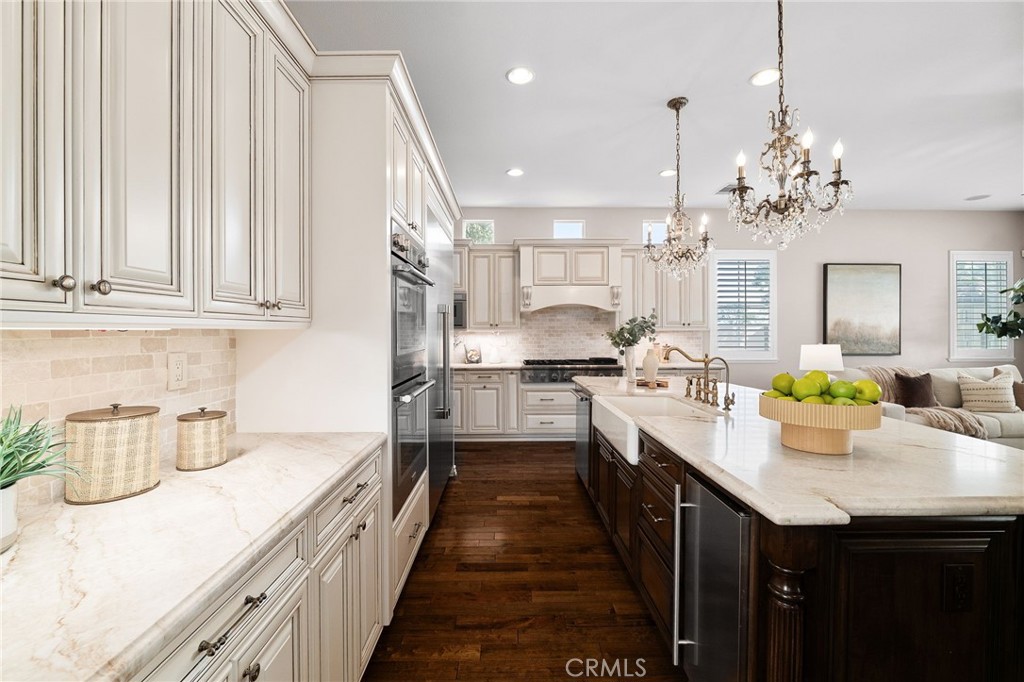 6364 Hidden Brook Place Rancho Cucamonga, CA 91739 - Photo 21 of 61 a kitchen with kitchen island granite countertop lots of counter top space and stainless steel appliances