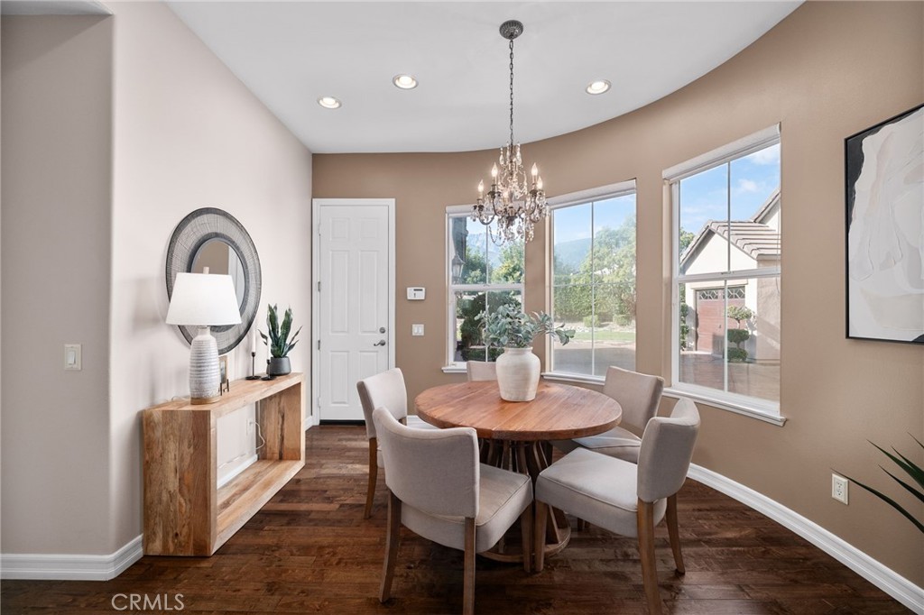 6364 Hidden Brook Place Rancho Cucamonga, CA 91739 - Photo 26 of 61 a view of a dining room with furniture window and wooden floor