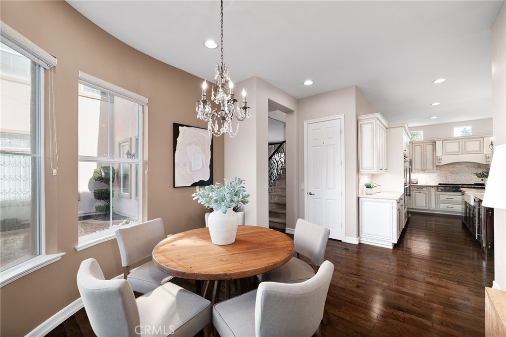 6364 Hidden Brook Place Rancho Cucamonga, CA 91739 - Photo 27 of 61 a view of a dining room with furniture wooden floor and chandelier