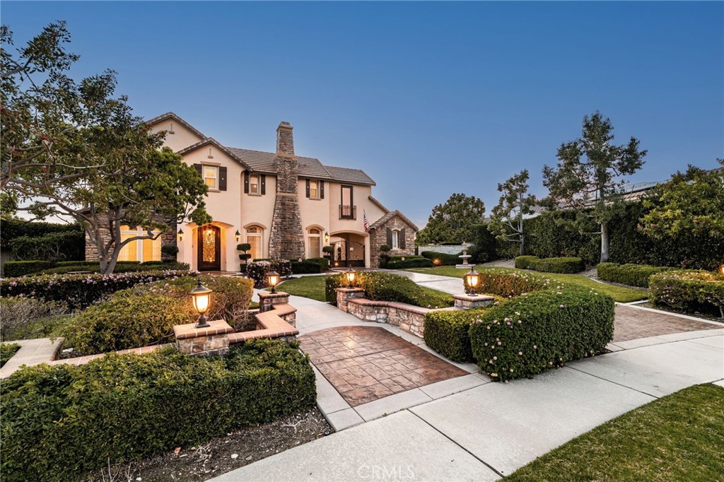 6364 Hidden Brook Place Rancho Cucamonga, CA 91739 - Photo 3 of 61 a front view of a house with a yard