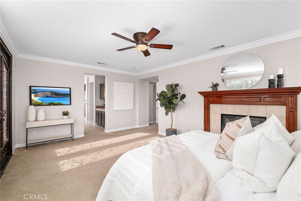 6364 Hidden Brook Place Rancho Cucamonga, CA 91739 - Photo 36 of 61 a bedroom with a large bed and a chandelier