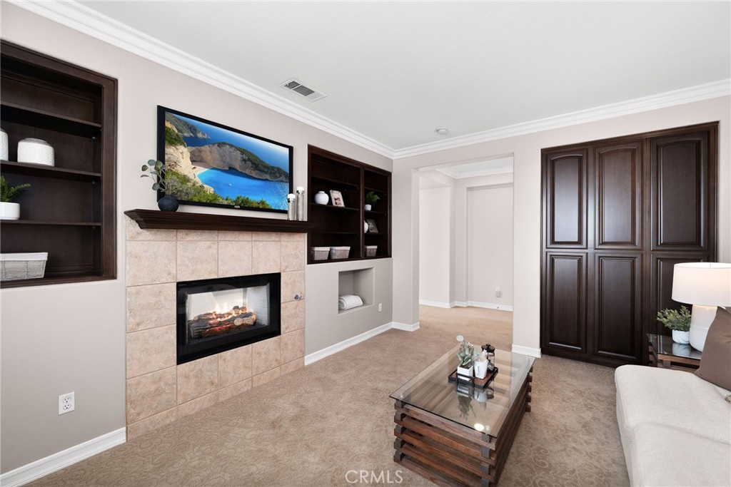 6364 Hidden Brook Place Rancho Cucamonga, CA 91739 - Photo 39 of 61 a living room with furniture and a fireplace