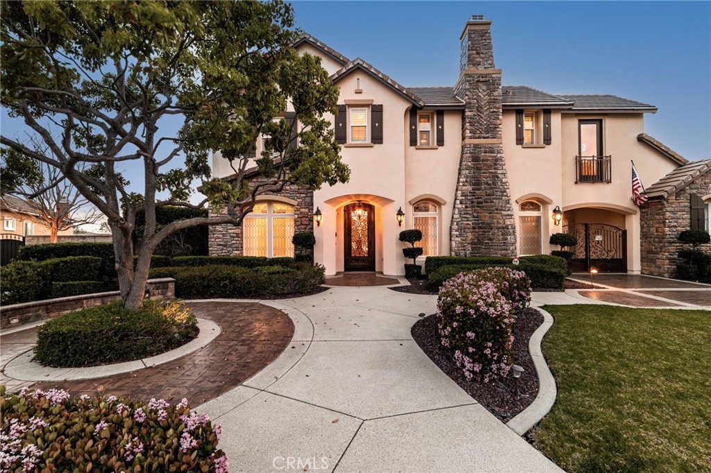 6364 Hidden Brook Place Rancho Cucamonga, CA 91739 - Photo 4 of 61 a front view of a house with garden and plants