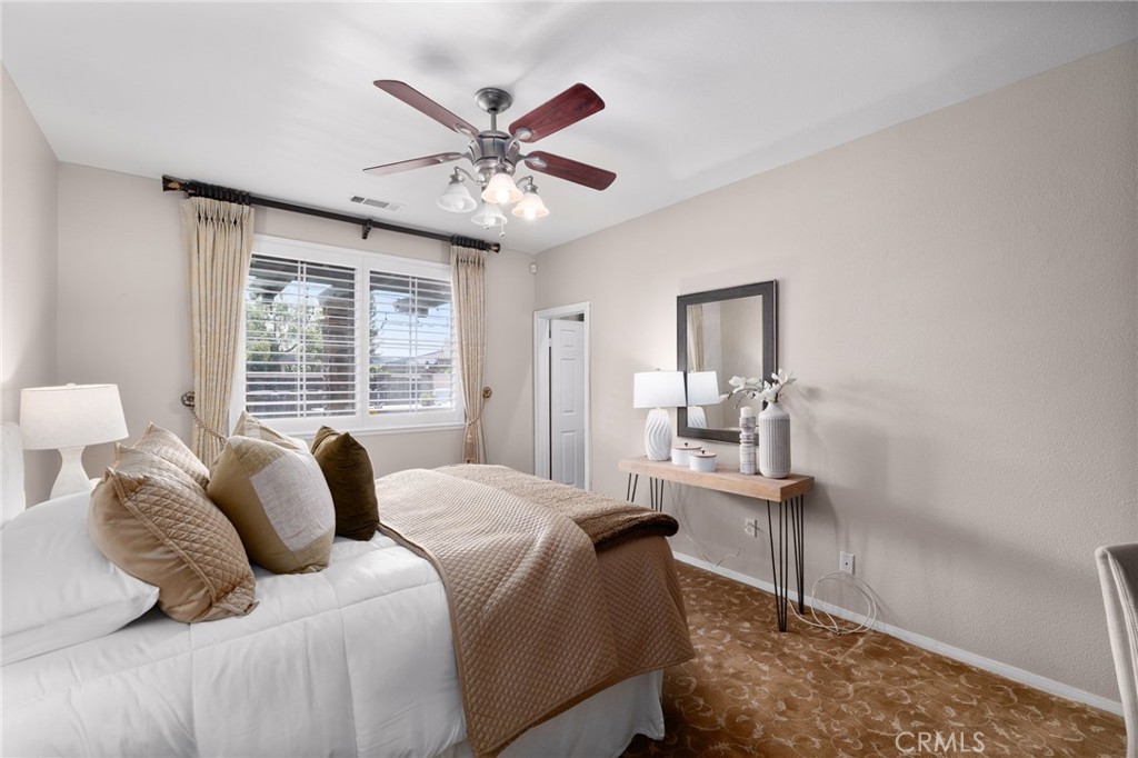 6364 Hidden Brook Place Rancho Cucamonga, CA 91739 - Photo 41 of 61 a bedroom with a large bed and a chandelier