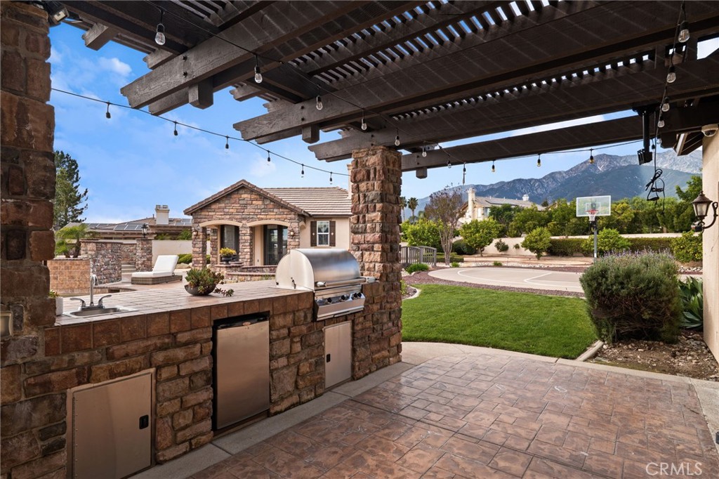6364 Hidden Brook Place Rancho Cucamonga, CA 91739 - Photo 46 of 61 a view of a porch with a table and chairs
