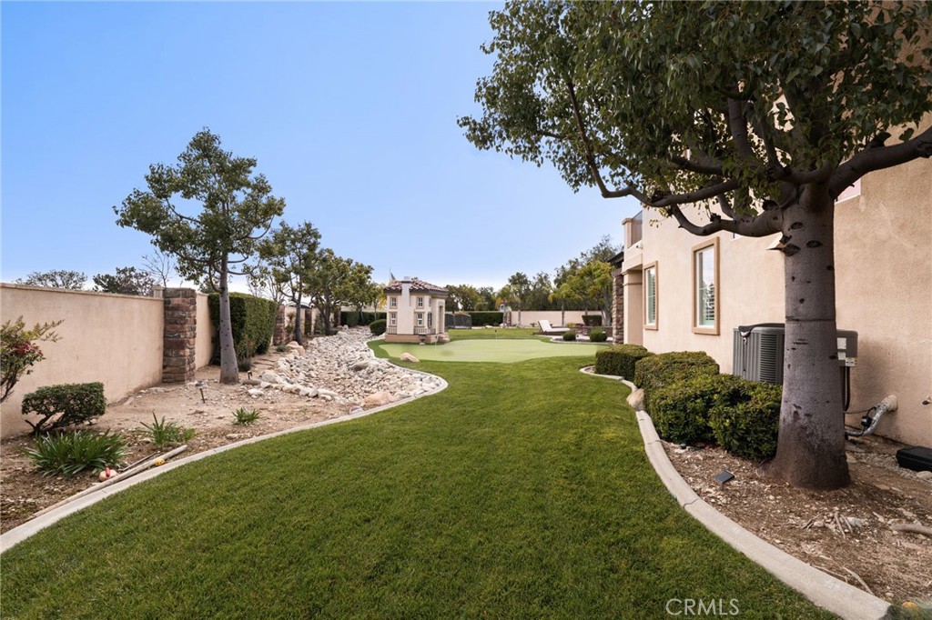 6364 Hidden Brook Place Rancho Cucamonga, CA 91739 - Photo 49 of 61 a view of a yard with plants and large trees
