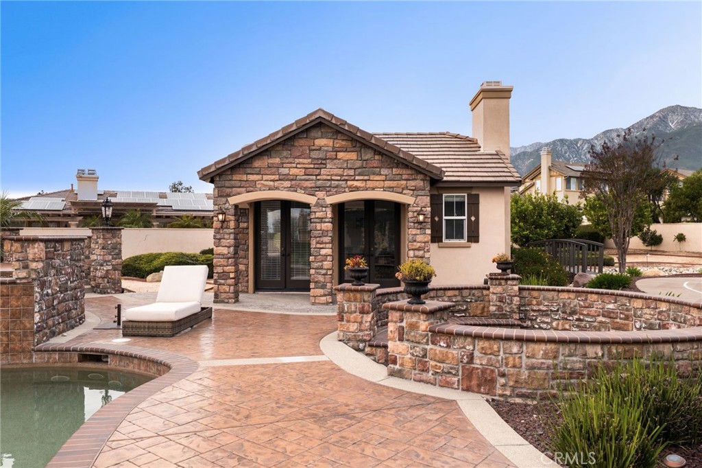 6364 Hidden Brook Place Rancho Cucamonga, CA 91739 - Photo 56 of 61 a front view of a house with swimming pool