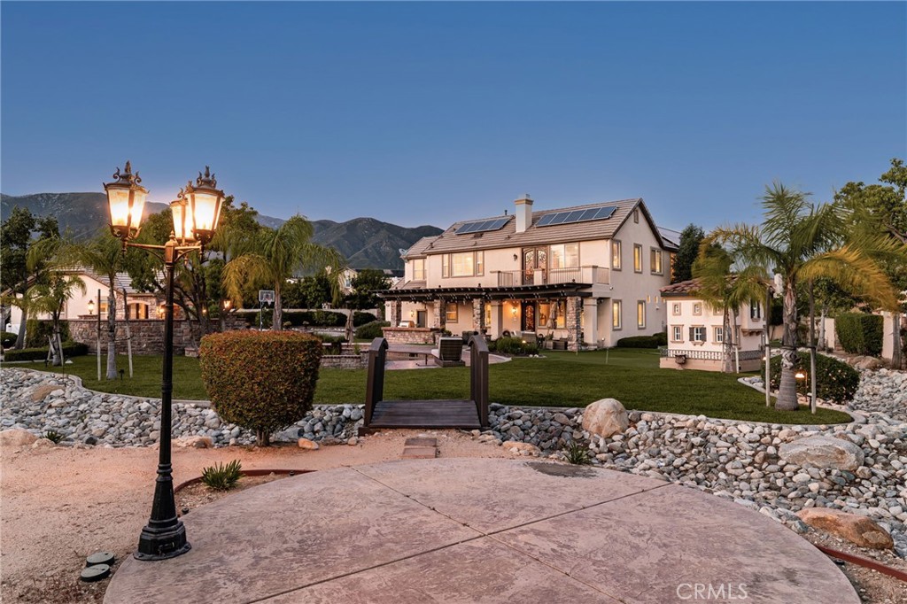 6364 Hidden Brook Place Rancho Cucamonga, CA 91739 - Photo 9 of 61 a view of a house with a yard