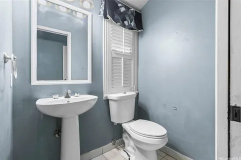 a bathroom with a sink toilet and mirror
