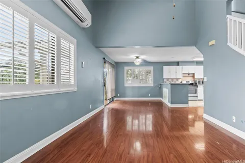 a view of a kitchen with wooden floor and windows