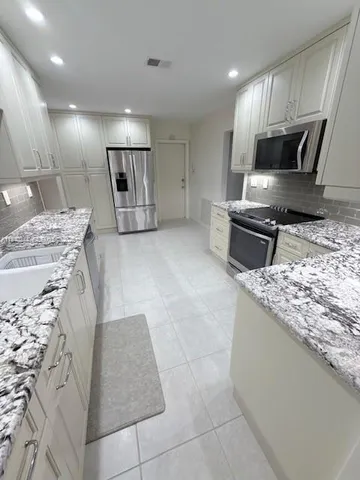 a view of a livingroom with an empty space and a window