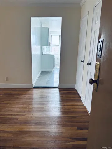 a view of a hallway view with wooden floor and staircase