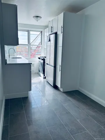 a kitchen with a refrigerator and a sink