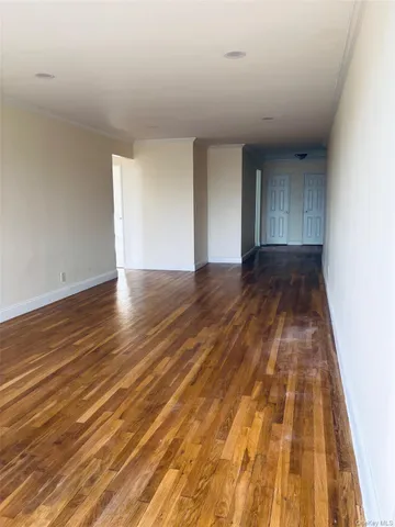a view of room with wooden floor