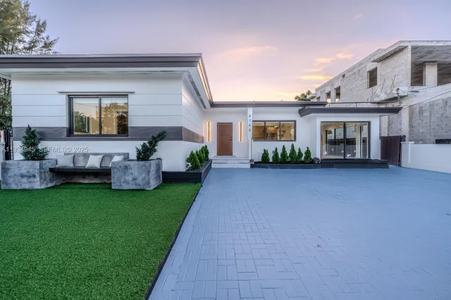 a front view of house with yard and green space