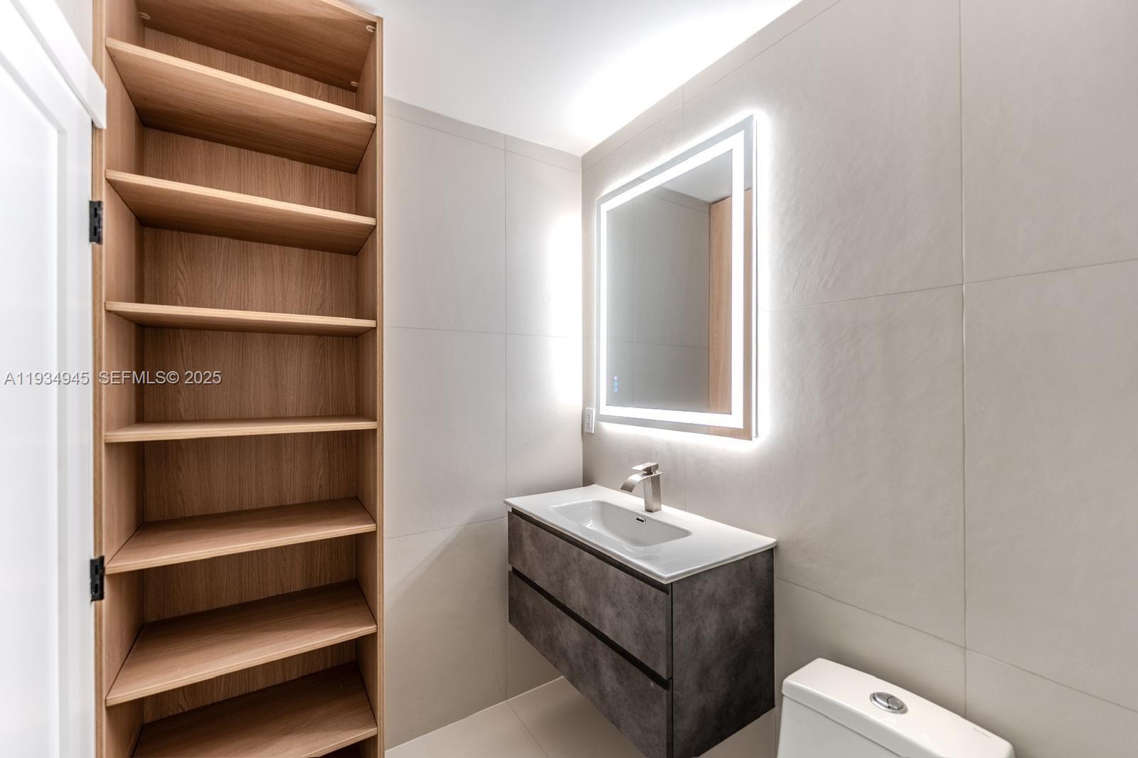 4144 Alton Road Miami Beach, FL 33140 - Photo 16 of 17 a bathroom with a sink and a toilet