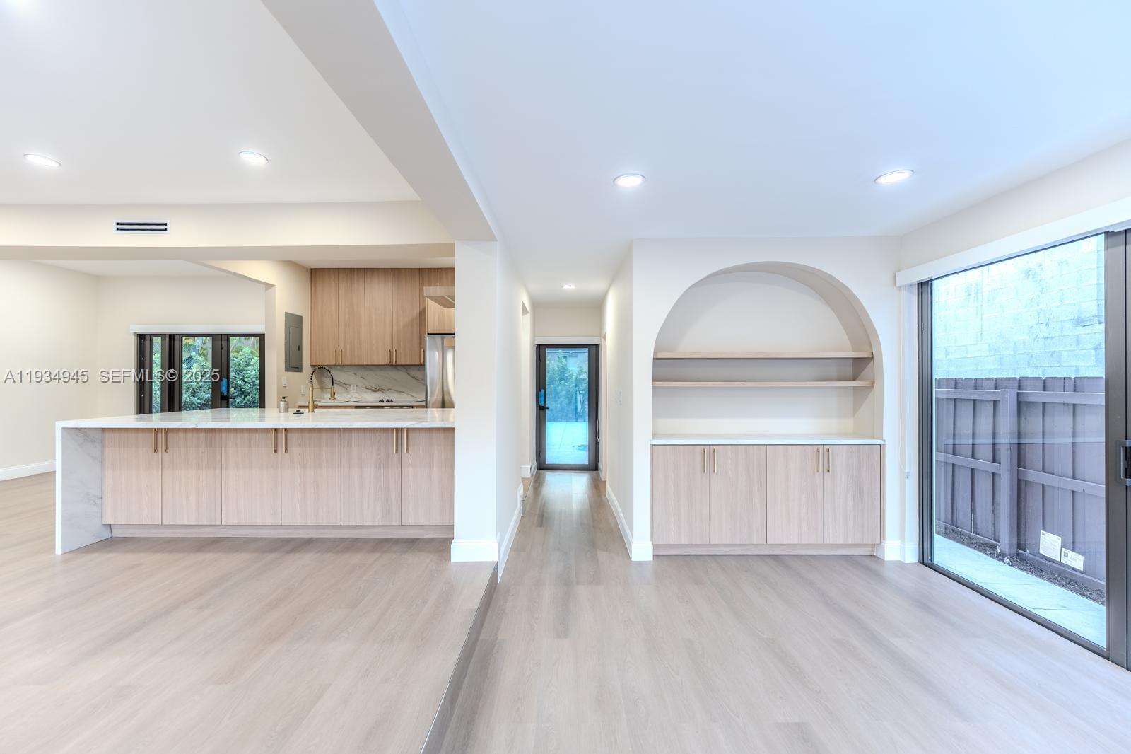 4144 Alton Road Miami Beach, FL 33140 - Photo 8 of 17 a view of kitchen with wooden floor and electronic appliances