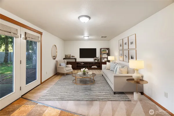 a living room with furniture and a flat screen tv