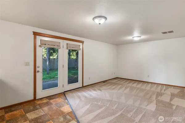 an empty room with sliding door and windows