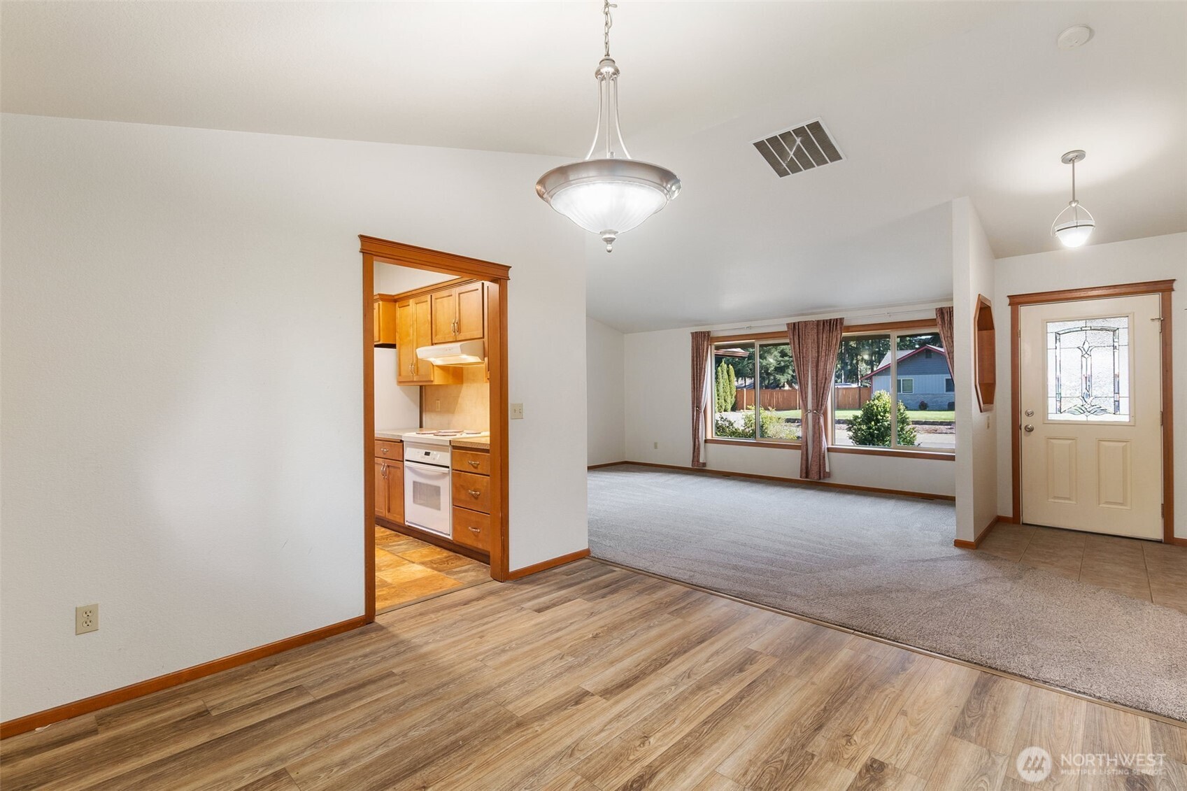 6107 189th Loop Southwest Rochester, WA 98579 - Photo 16 of 38 a view of an empty room with window and wooden floor