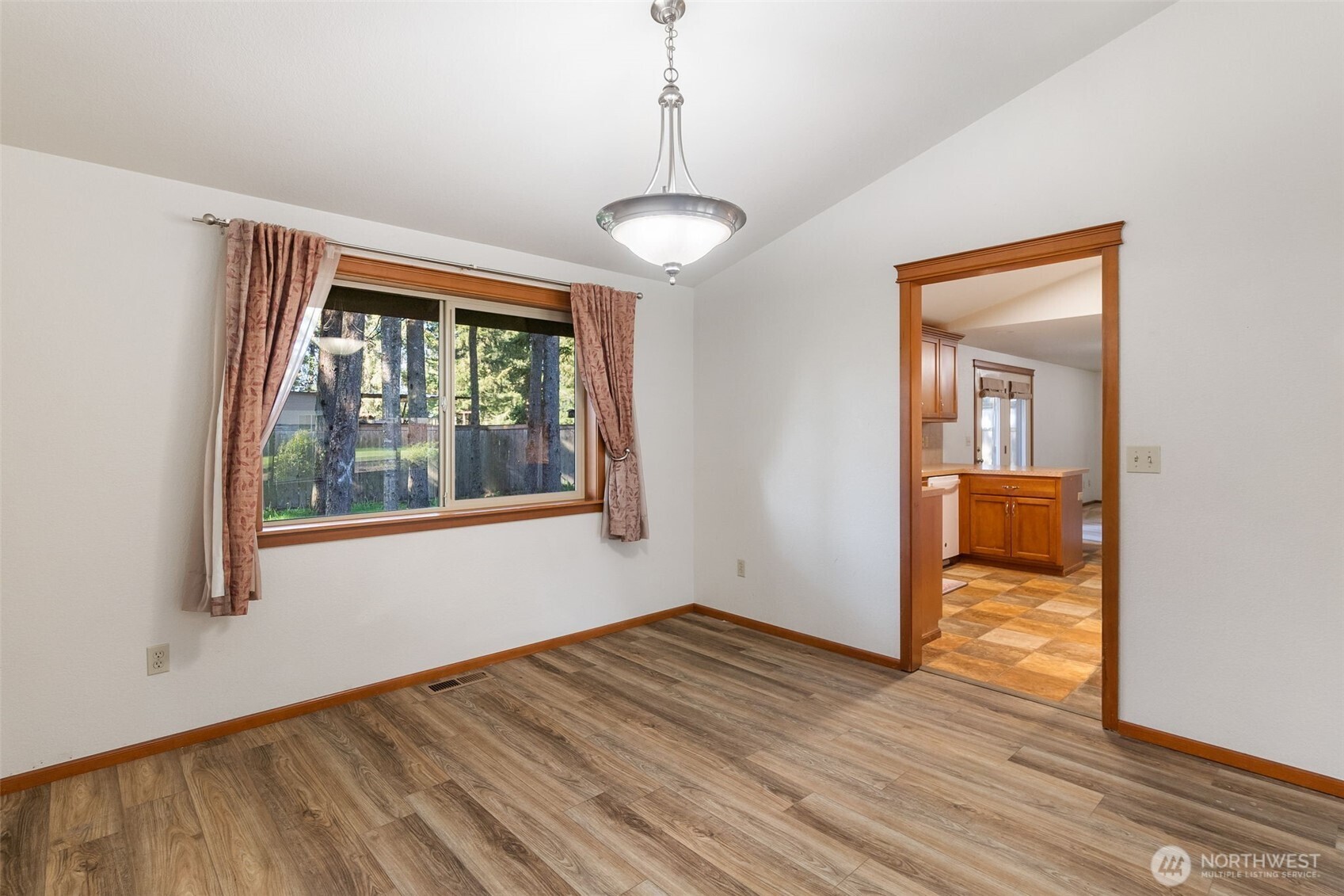 6107 189th Loop Southwest Rochester, WA 98579 - Photo 18 of 38 a view of an empty room with wooden floor and a window