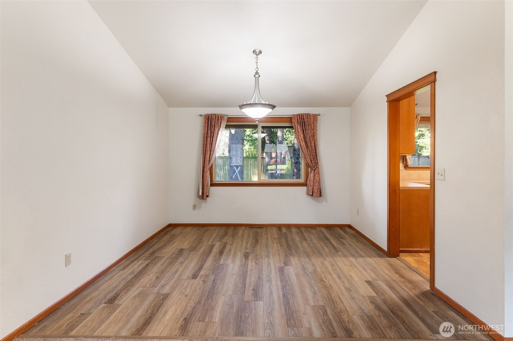 6107 189th Loop Southwest Rochester, WA 98579 - Photo 19 of 38 wooden floor in an empty room with a window
