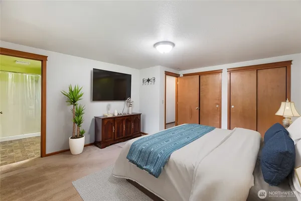 a bedroom with a bed and a dresser