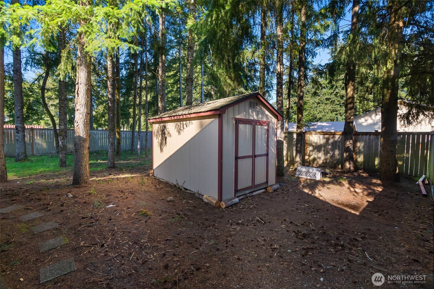 6107 189th Loop Southwest Rochester, WA 98579 - Photo 29 of 38 a view of a small house with a small yard and large tree
