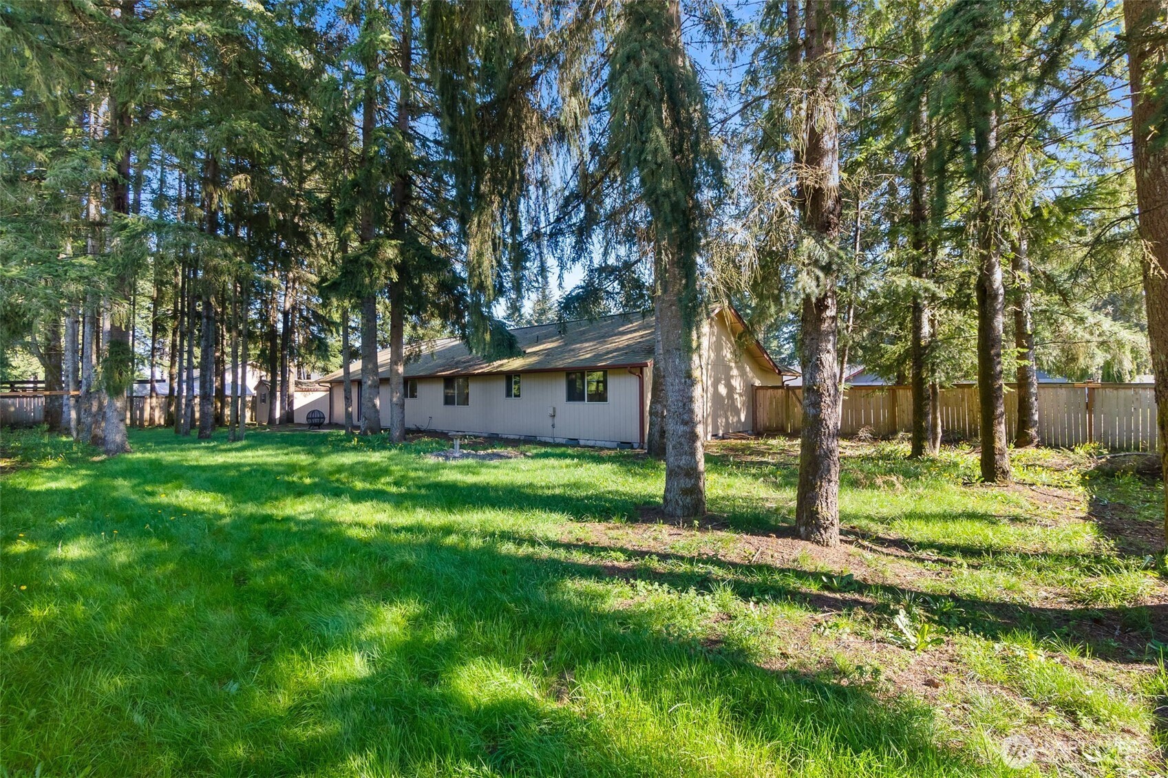 6107 189th Loop Southwest Rochester, WA 98579 - Photo 3 of 38 a view of a house with yard and tree s