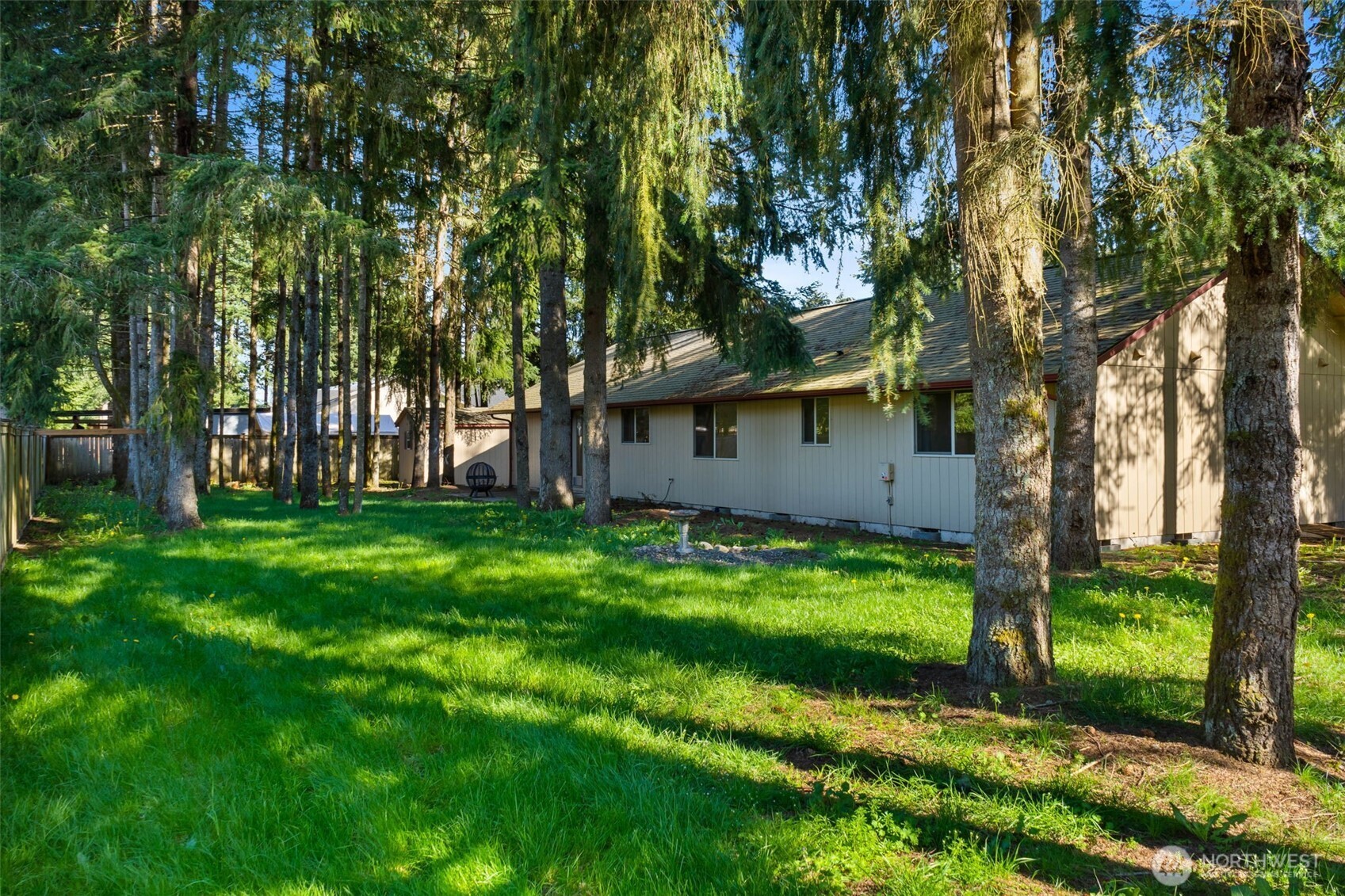 6107 189th Loop Southwest Rochester, WA 98579 - Photo 34 of 38 a view of a backyard with large trees