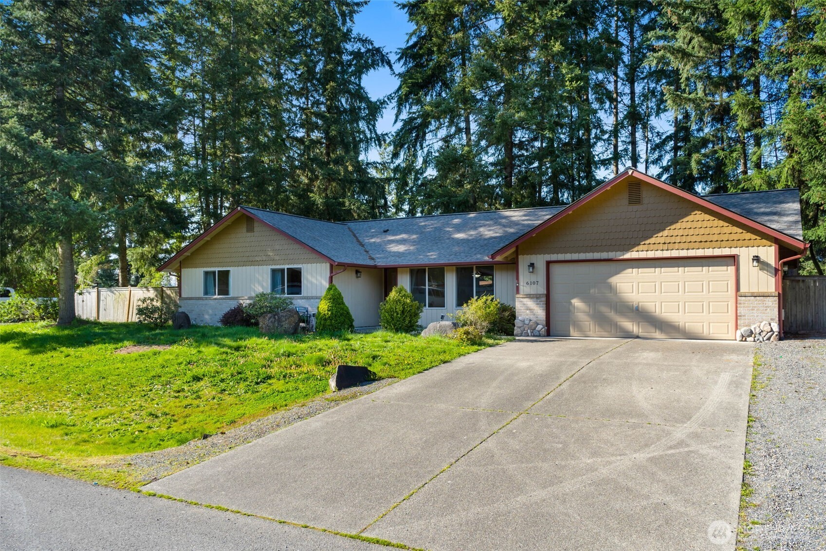 6107 189th Loop Southwest Rochester, WA 98579 - Photo 37 of 38 a front view of a house with a yard and garage