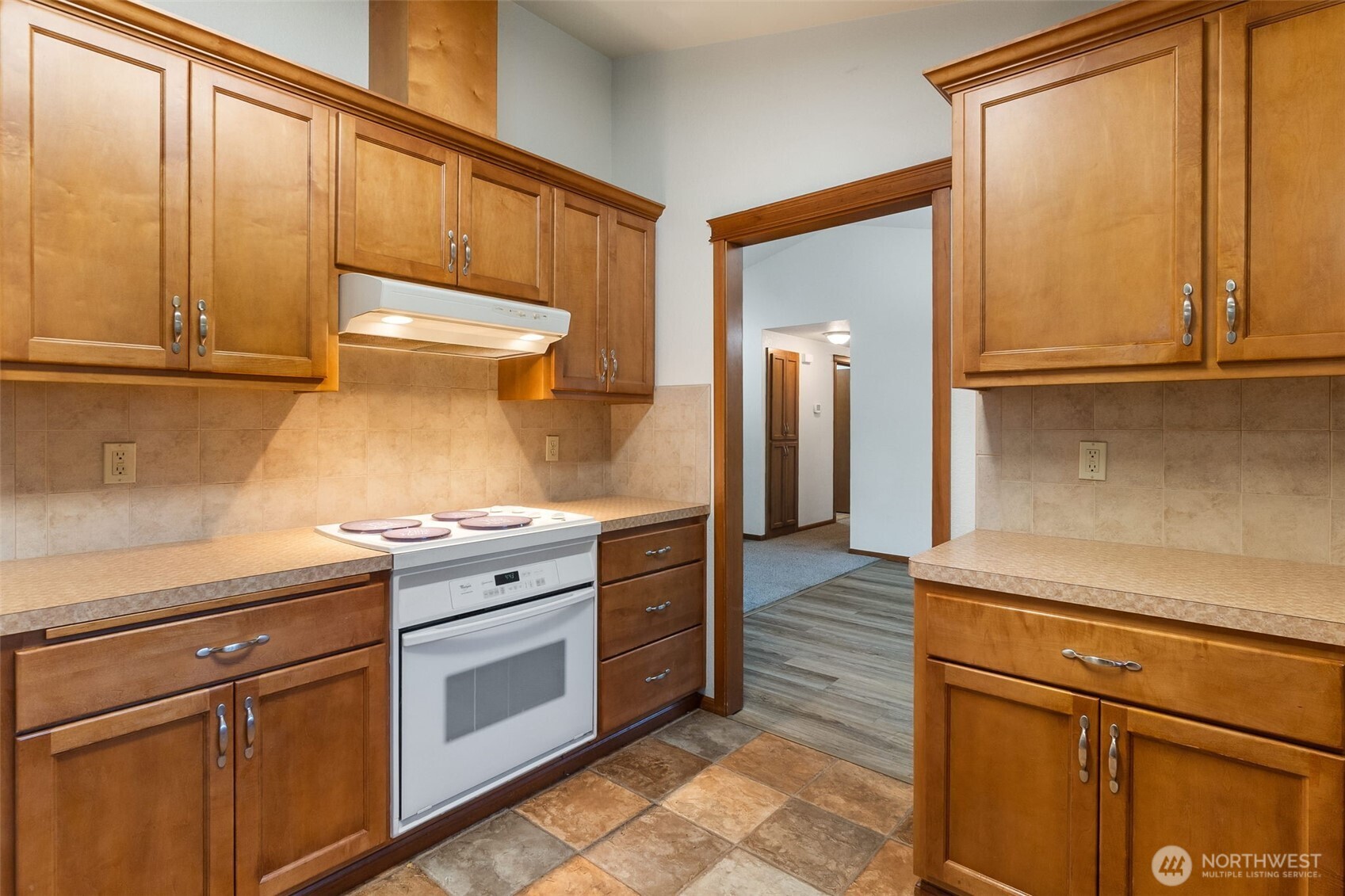 6107 189th Loop Southwest Rochester, WA 98579 - Photo 6 of 38 a kitchen with granite countertop cabinets stainless steel appliances and a sink