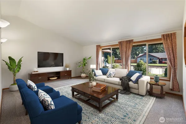 a living room with furniture flat screen tv and a large window