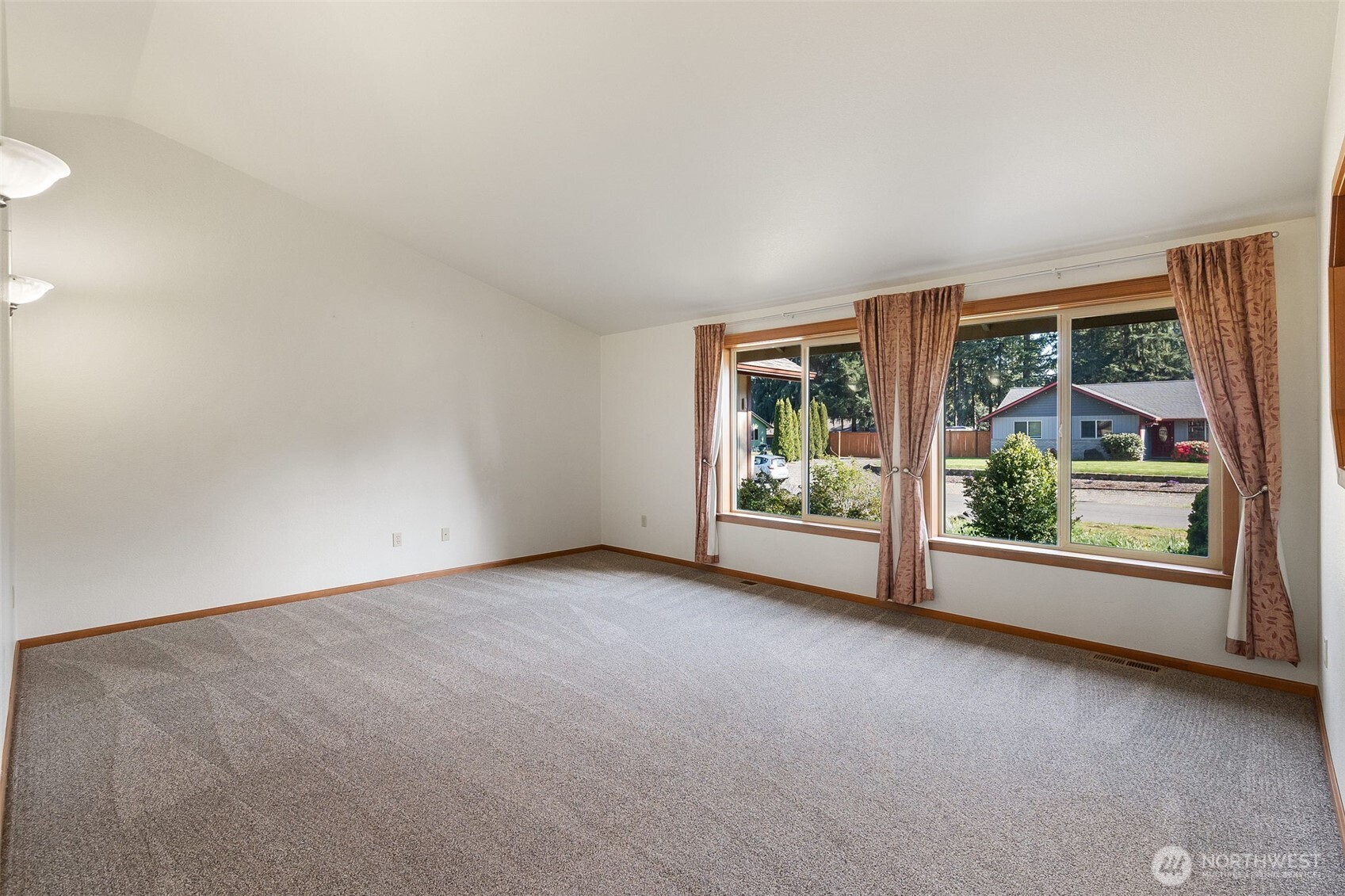 6107 189th Loop Southwest Rochester, WA 98579 - Photo 9 of 38 an empty room with floor to ceiling window and an outdoor view