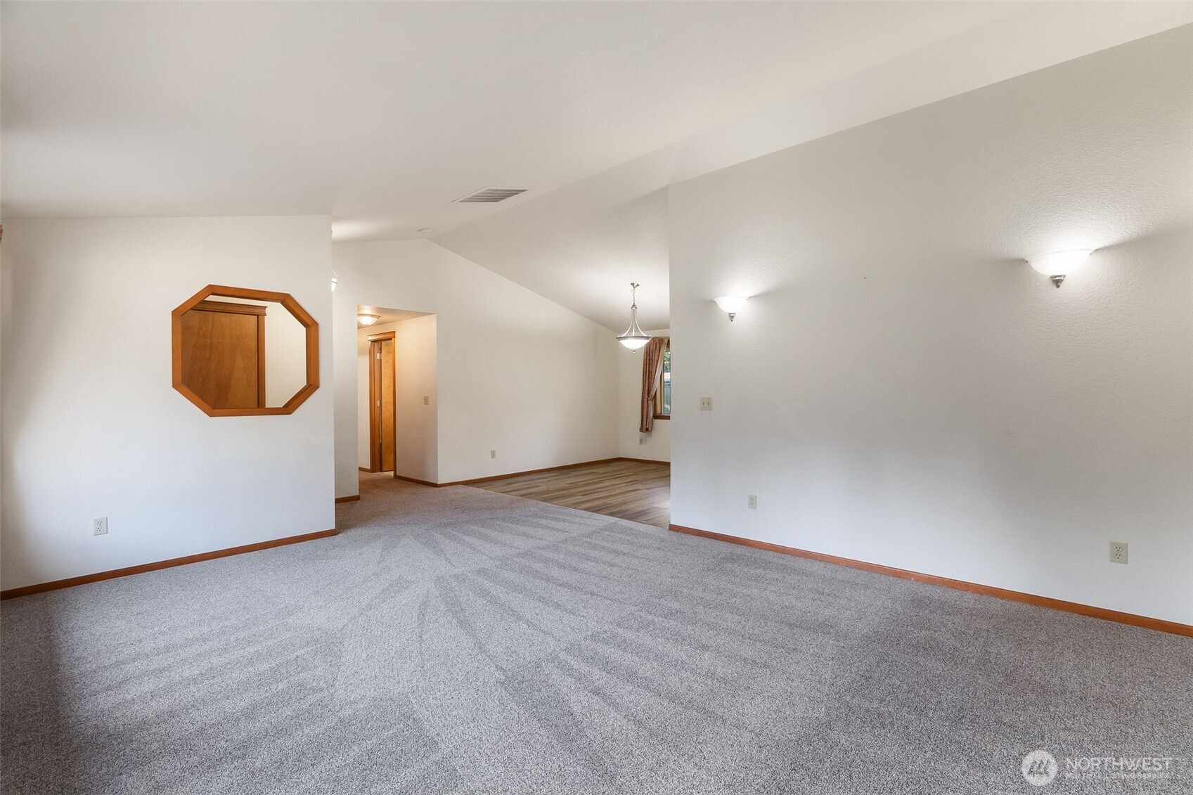 6107 189th Loop Southwest Rochester, WA 98579 - Photo 10 of 38 an empty room with wooden floor and glass door