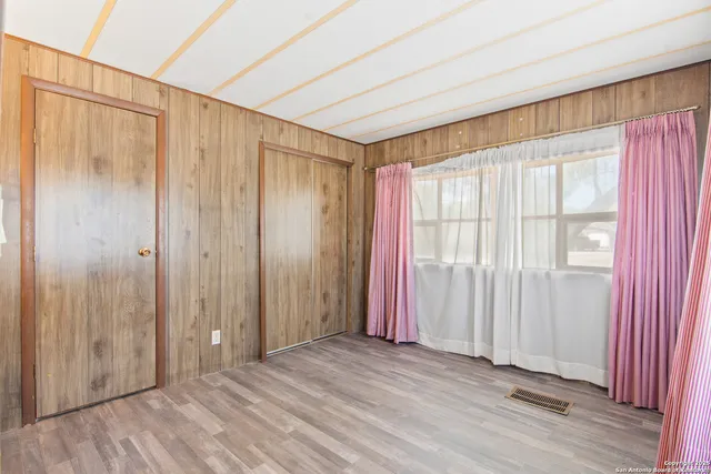 a view of a room with wooden walls