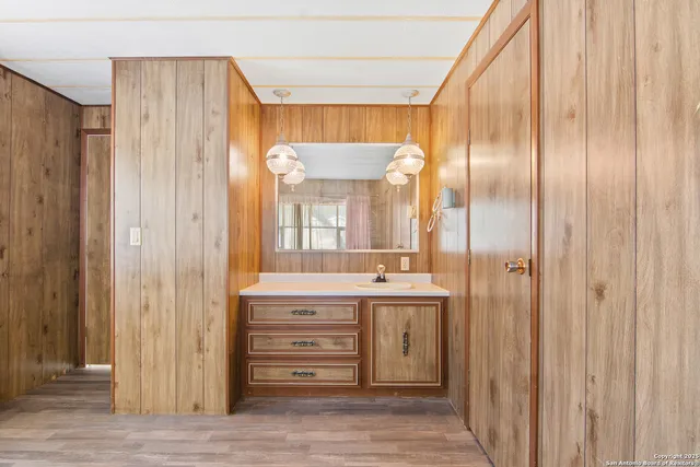 a bathroom with a double vanity sink and a mirror