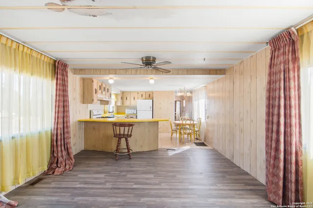 a view of kitchen with furniture and wooden floor
