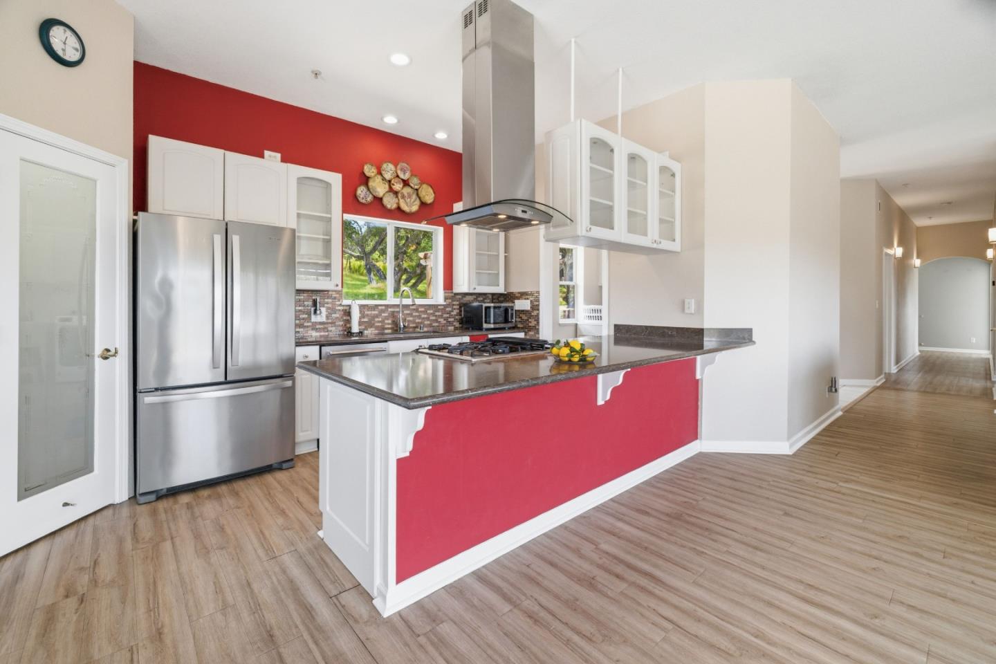 19269 Mallory Canyon Road, Unit D Salinas, CA 93907 - Photo 9 of 77 a kitchen with stainless steel appliances granite countertop a refrigerator a sink a stove and a wooden floors