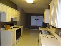 a kitchen with a stove a sink and a microwave