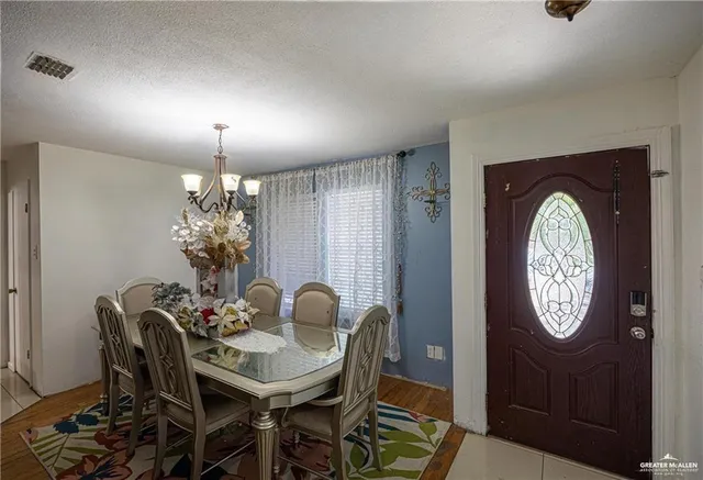 a view of a dining room with furniture and chandelier