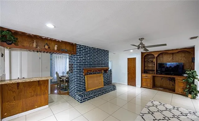 a view of open kitchen stove refrigerator and cabinets