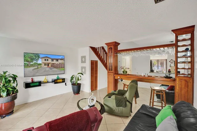 a living room with furniture a couch and potted plant