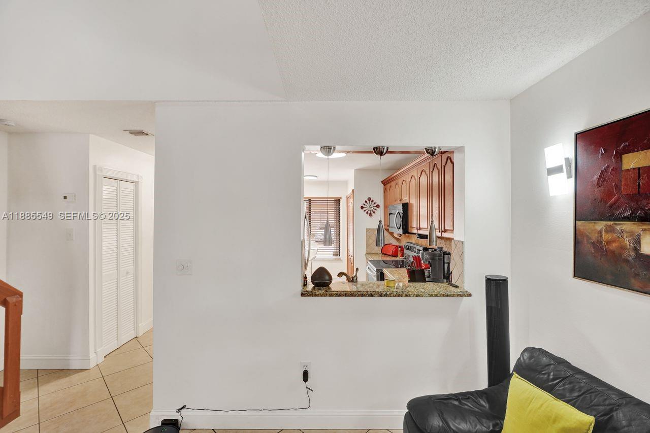 14201 Southwest 57th Lane, Unit 1A7 Miami, FL 33183 - Photo 17 of 48 a view of room with cabinet and mirror