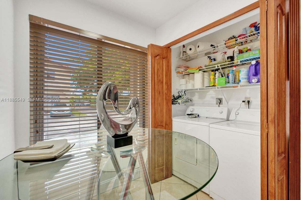 14201 Southwest 57th Lane, Unit 1A7 Miami, FL 33183 - Photo 26 of 48 a bathroom with a sink a mirror and shower
