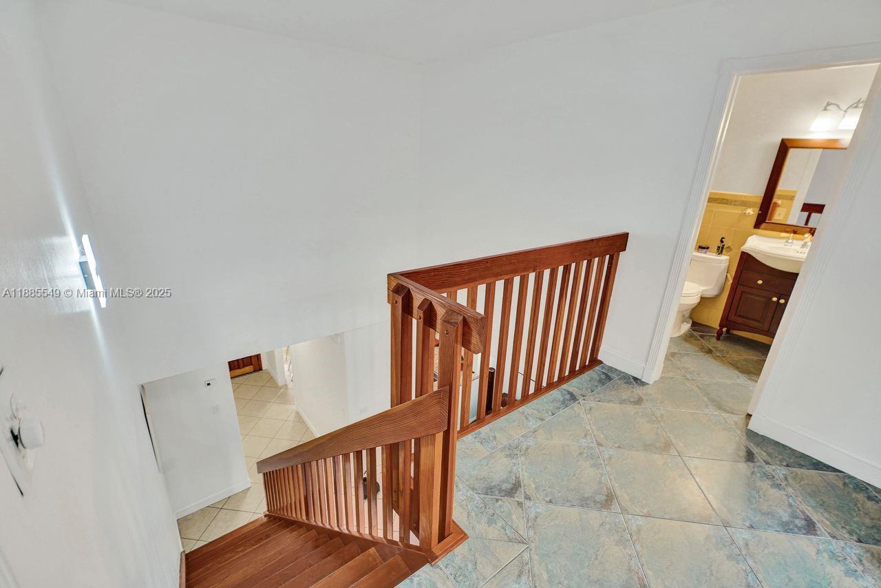 14201 Southwest 57th Lane, Unit 1A7 Miami, FL 33183 - Photo 27 of 48 a view of a hallway with staircase