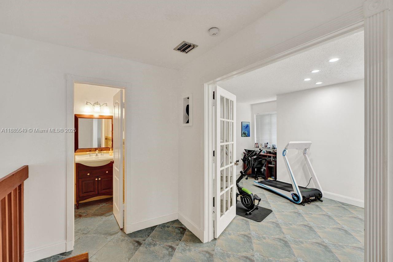 14201 Southwest 57th Lane, Unit 1A7 Miami, FL 33183 - Photo 28 of 48 a view of a room with gym equipment