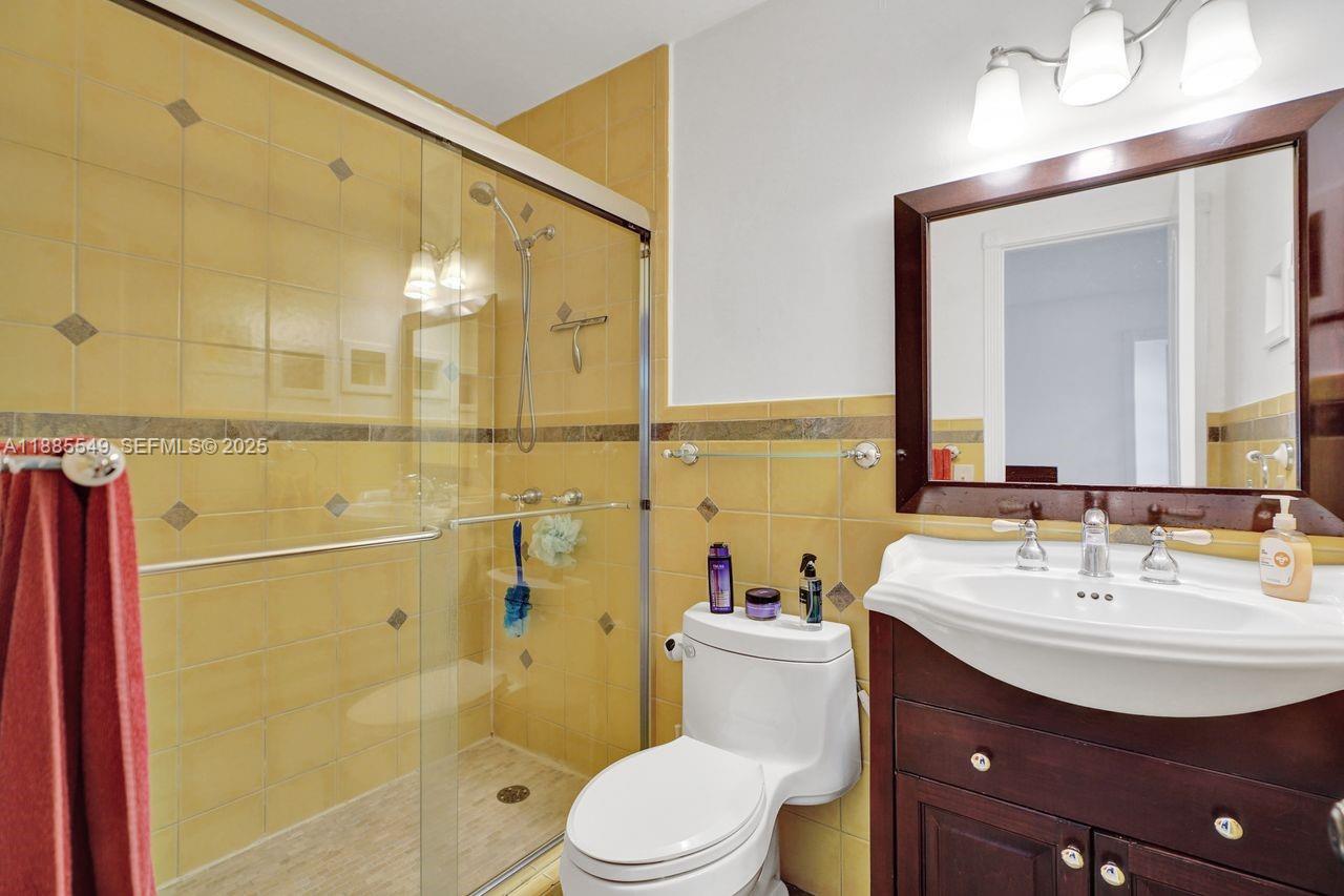 14201 Southwest 57th Lane, Unit 1A7 Miami, FL 33183 - Photo 29 of 48 a bathroom with a sink a toilet and shower