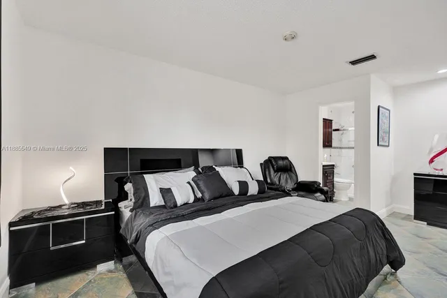 a bedroom with a bed and lamp