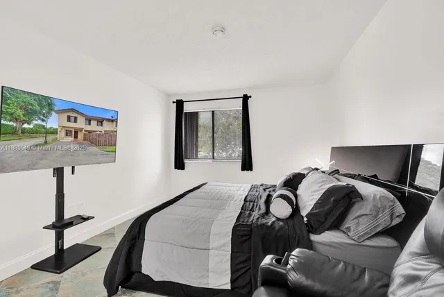 a bedroom with a bed and window